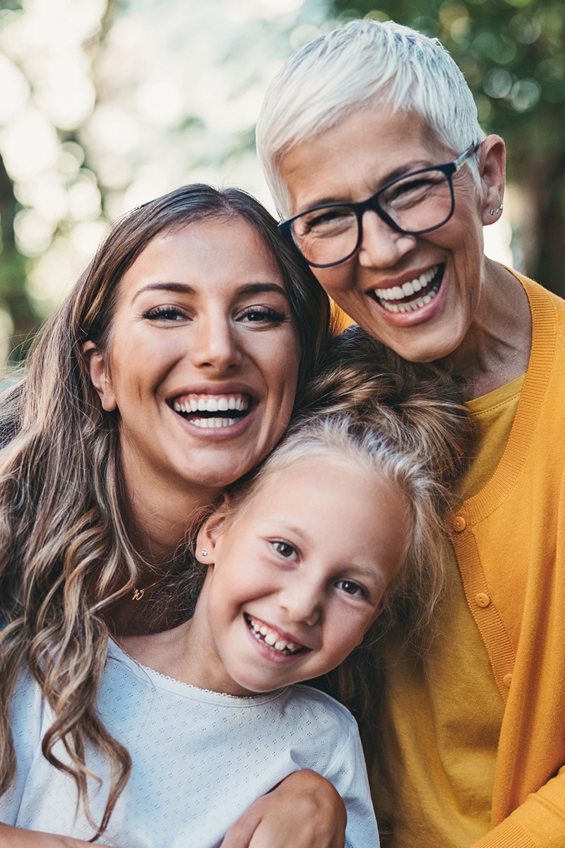 Three generations of one family smiling together